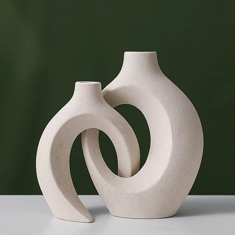Two ivory ceramic vases nested together, without flowers