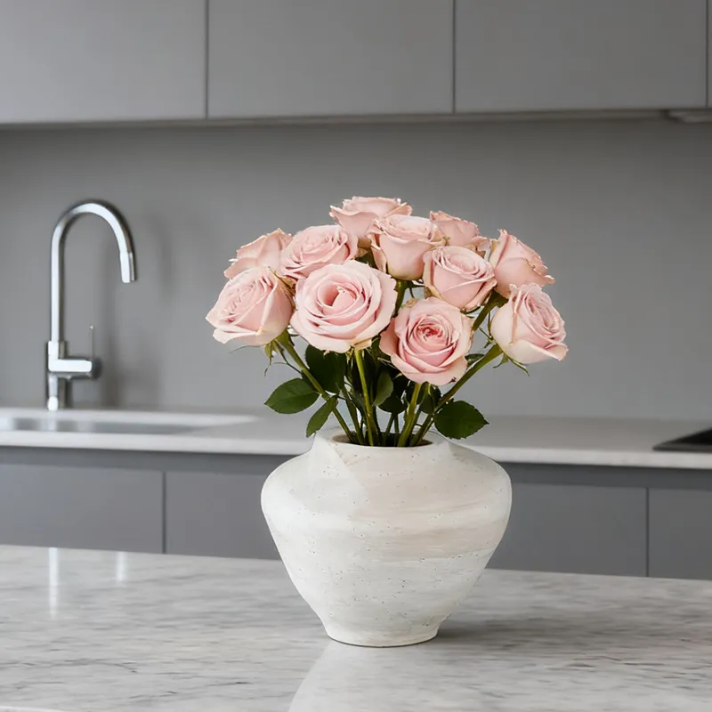 Small round vase on a kitchen counter with roses; flowers not included