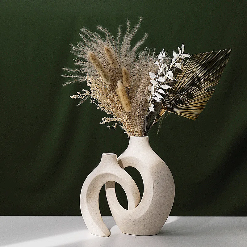 Interlocking vase pair styled with dried stems; stems not included
