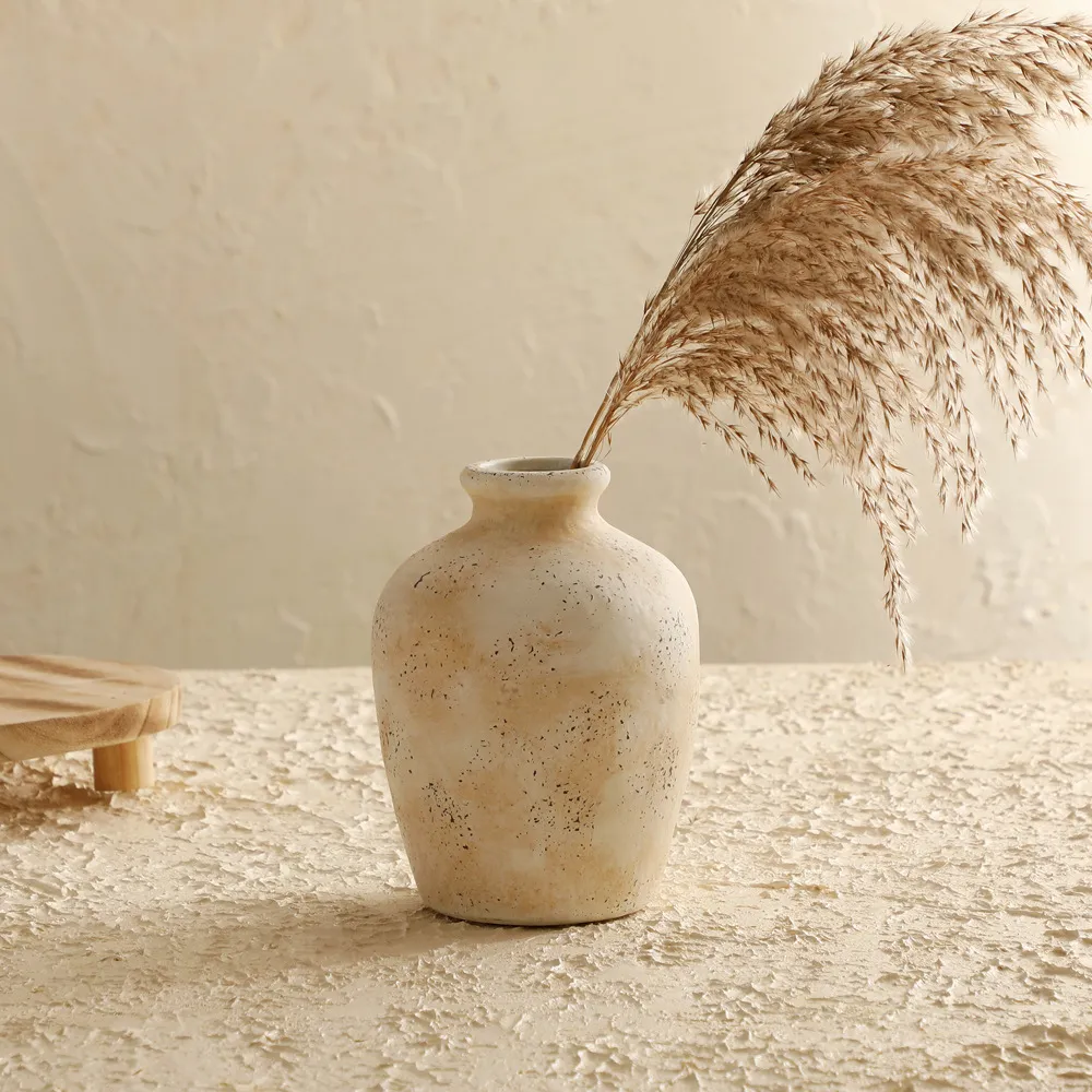 Cream vase styled with dried stems; stems not included